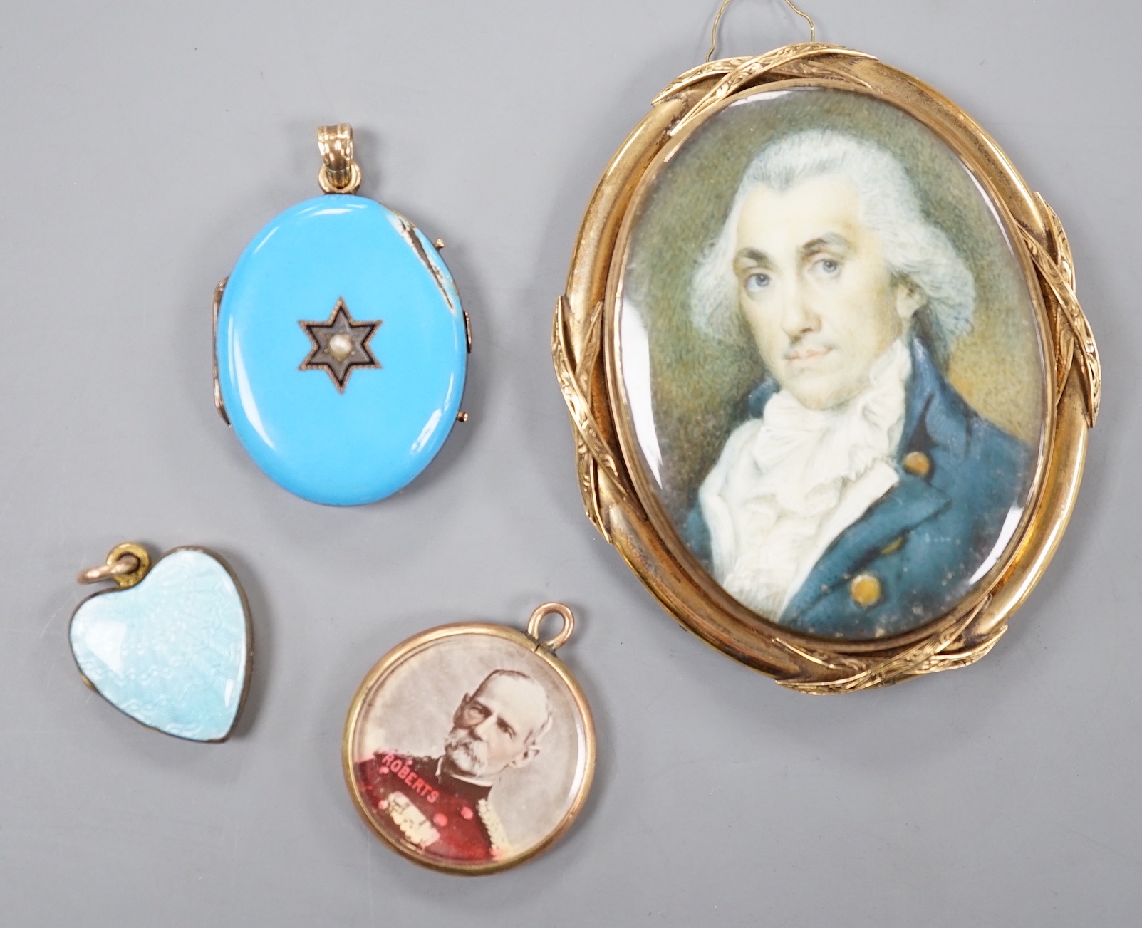 A 19th century yellow metal miniature oval portrait mourning brooch, 54mm, two enamelled lockets(a.f.) and one other small pendant.